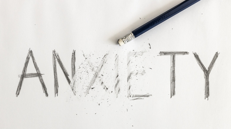 erasing "anxiety" word with pencil