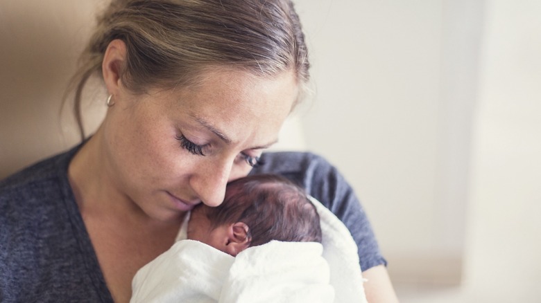 mother holds premature baby