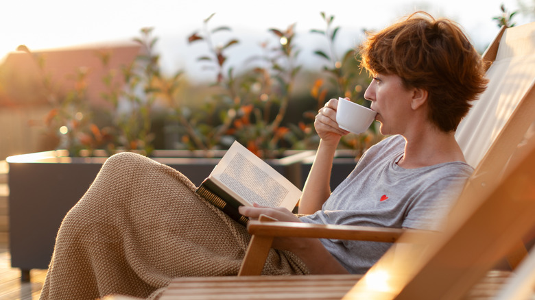 woman relaxing outside with tea