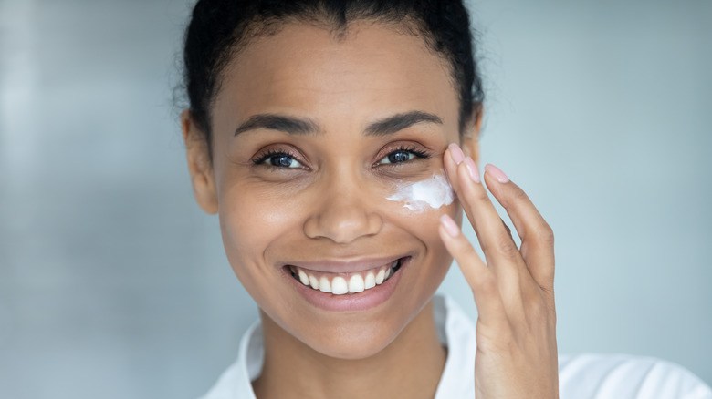 Woman applying skincare product