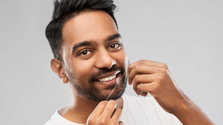 Man using dental floss 