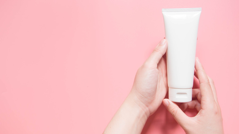 Hands holding lotion 