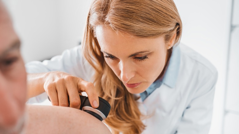 dermatologist examining a patient's skin