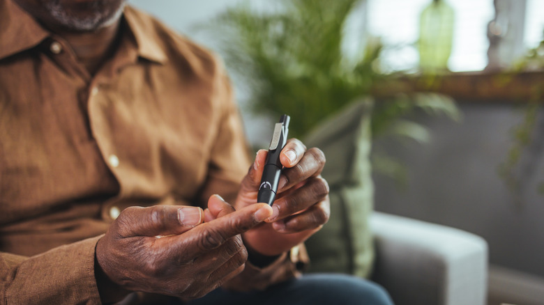 Man with diabetes testing blood sugar