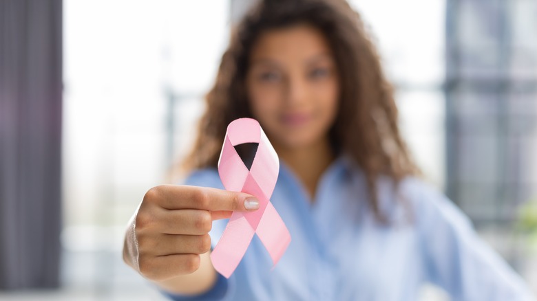 woman holding breast cancer awareness ribbon