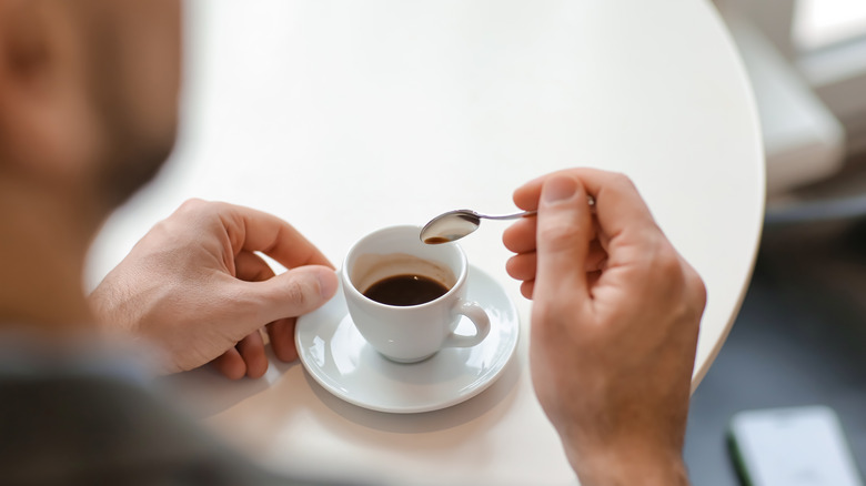 woman glasses smiling holding a cup of coffee