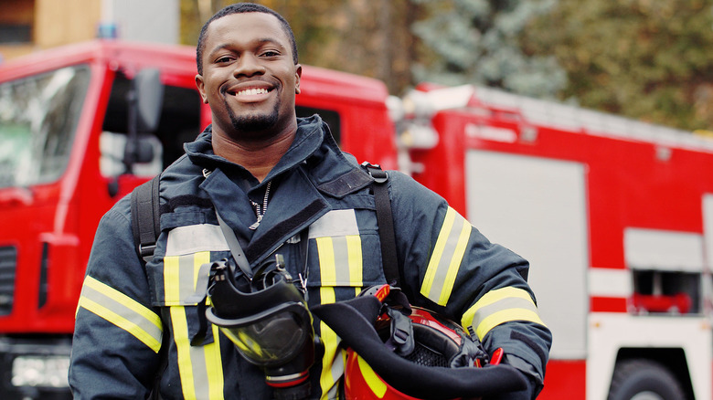 firefighter standing near fire truck