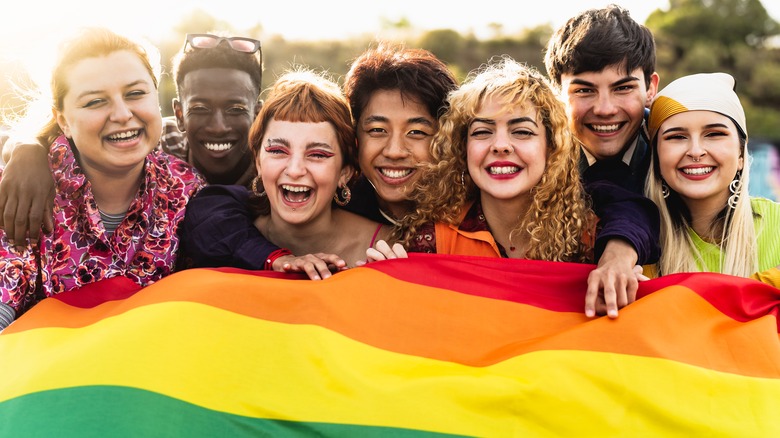 LGBTQ youth holding Pride flag