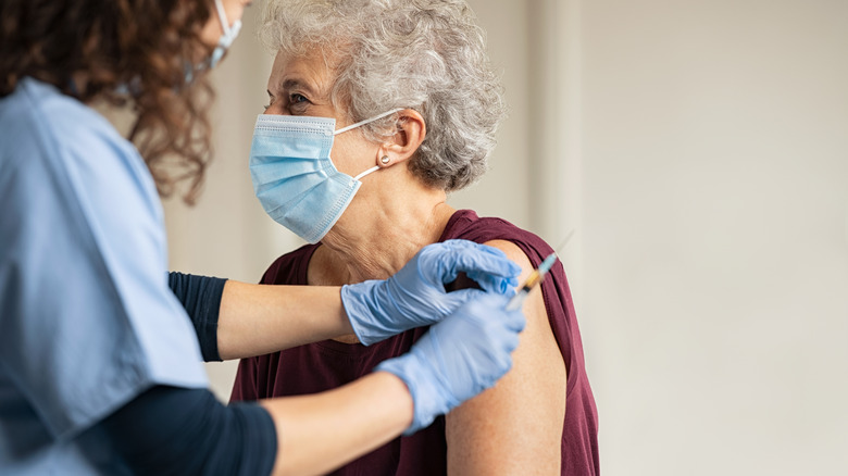 Elderly woman being vaccinated