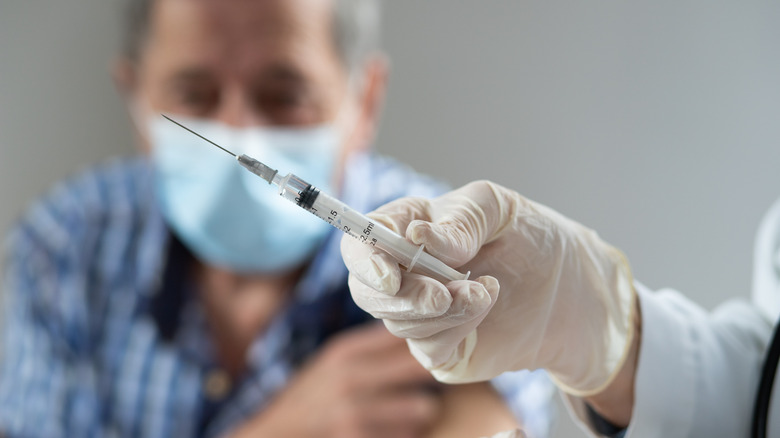 Elderly man receiving vaccine