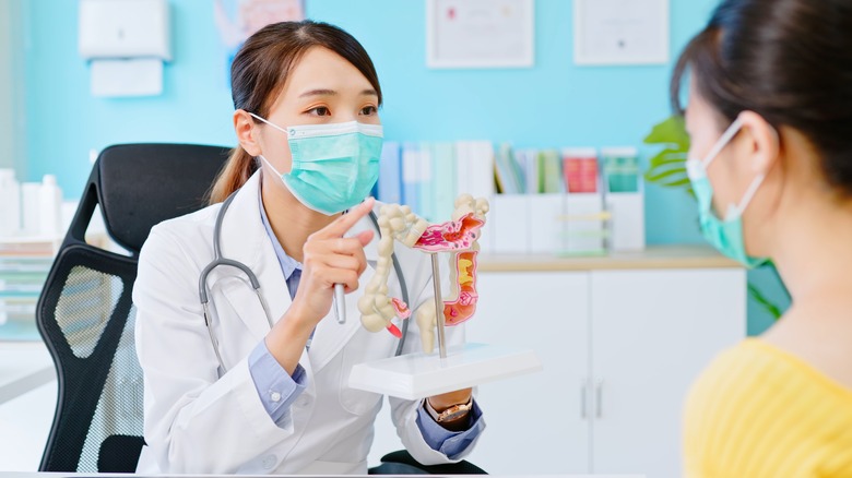 A doctor discusses a colonoscopy with a patient