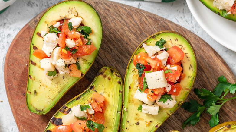 Grilled avocado with herbs and tomatoes