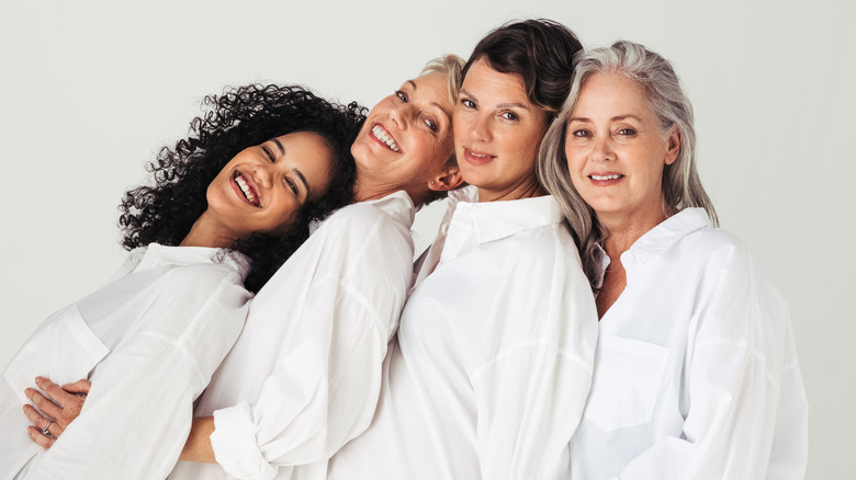 four diverse women smiling