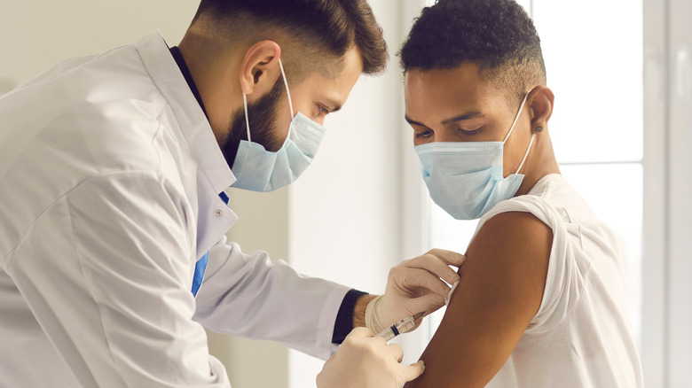 Young adult receiving vaccine