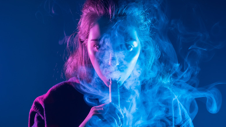 girl vaping surrounded by smoke