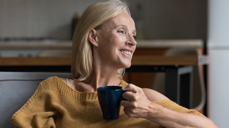 Older woman holding mug