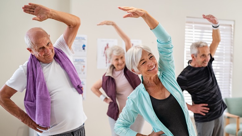 A group of seniors stretch together