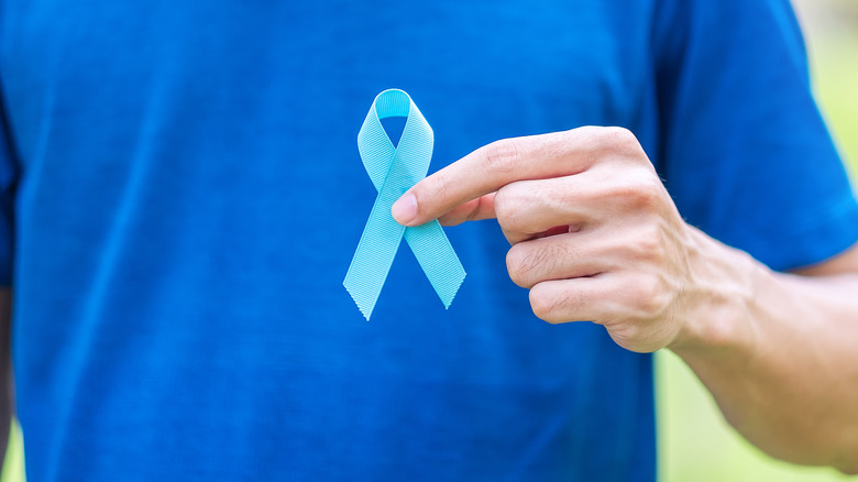 A man holds a prostate cancer awareness ribbon