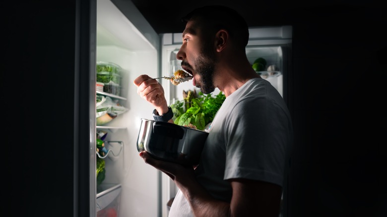 man eating night fridge