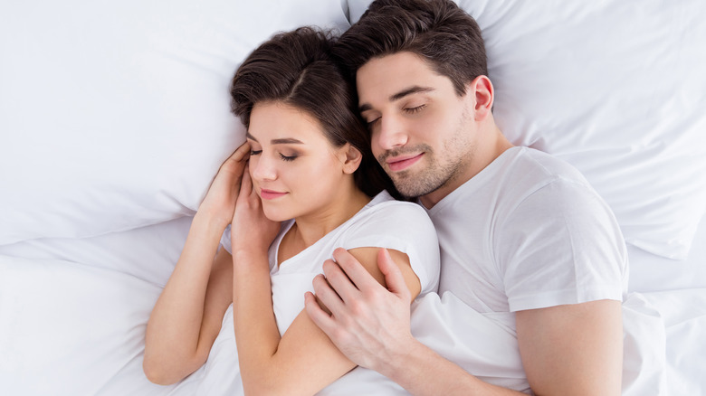 couple sleeping soundly in bed 