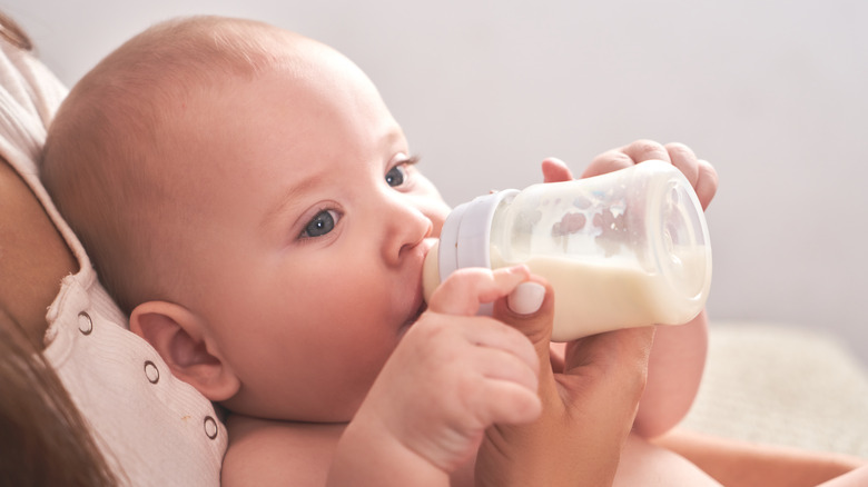 A baby drinking from a bottle