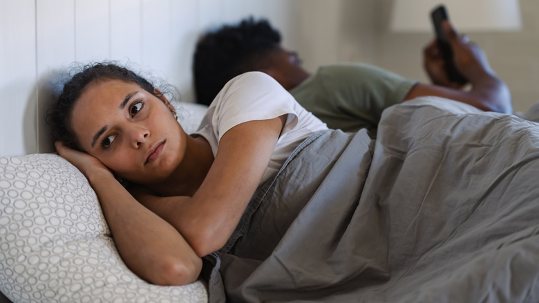 Woman looking stressed laying in bed
