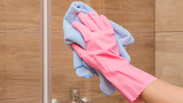 person cleaning a shower