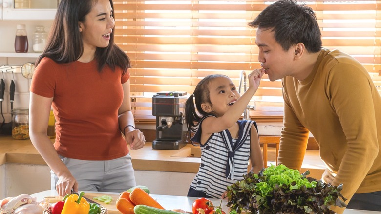 Asian family eat healthy foods in kitchen