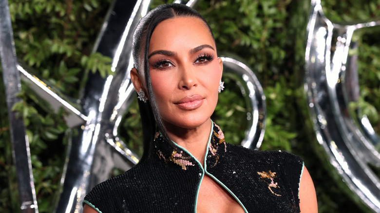 Kim Kardashian in a dress with an Asian neckline glowing for the photo