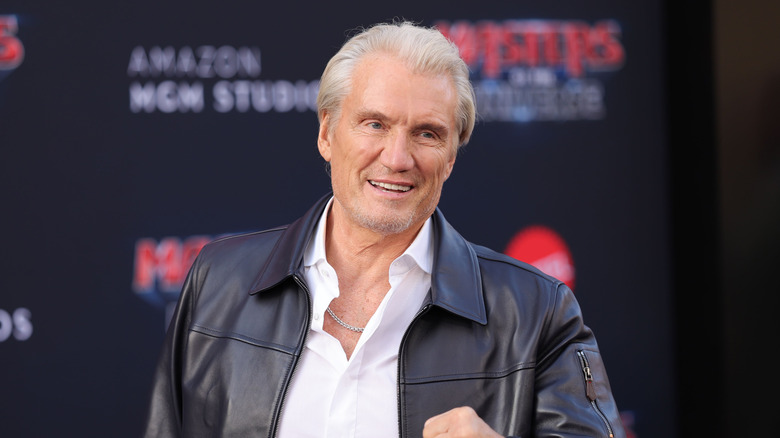 Dolph Lundgren posing in a black jacket