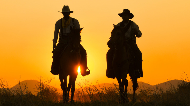 Silhouette of two cowboys