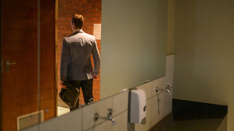 Office man walking out of bathroom