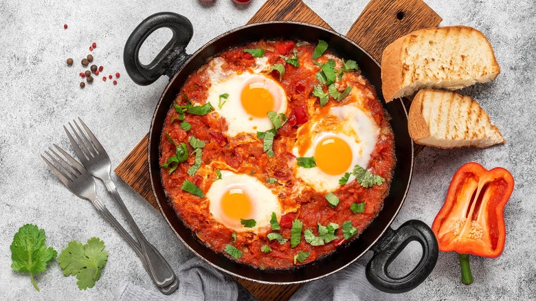 Sunny-side eggs on a skillet of vegetables