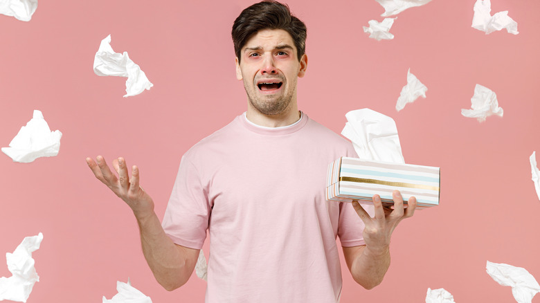 A man surrounded by tissues