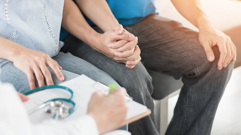 Young couple meeting with a doctor
