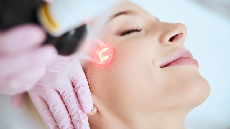 A woman getting a laser treatment done