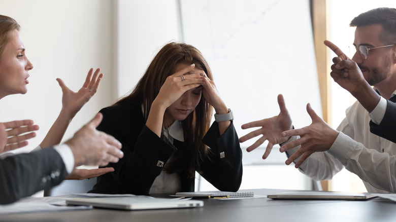 Stressed woman with hands on head