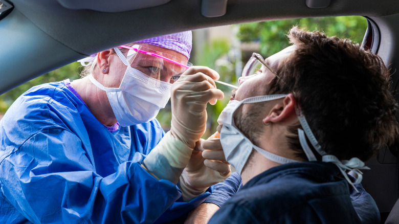 A doctor tests someone for coronavirus