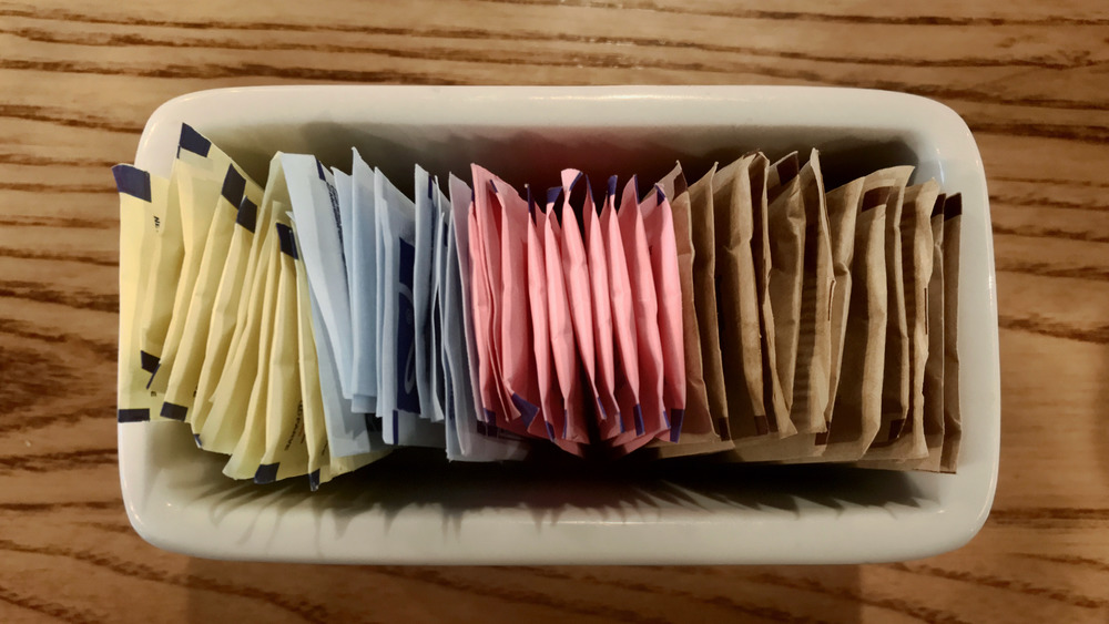 Sweetener packets in a dish