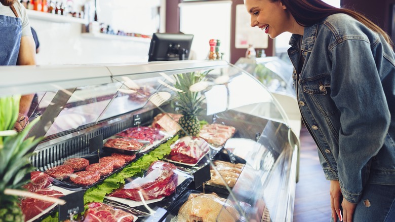 customer perusing meat counter