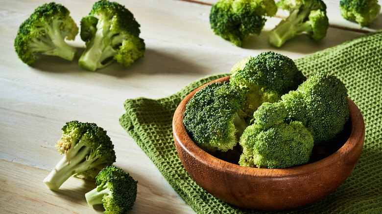 A bowl of broccoli on a rustic table
