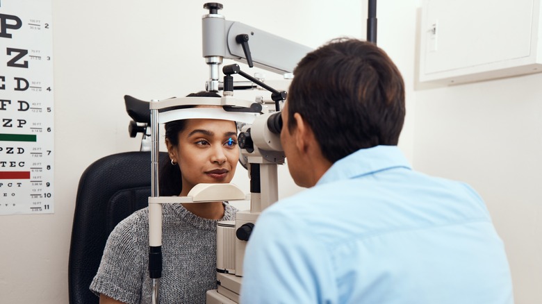 Optometrist examining patient