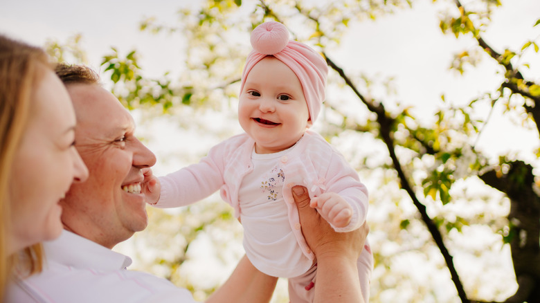 Baby with a cleft lip smiling and laughing