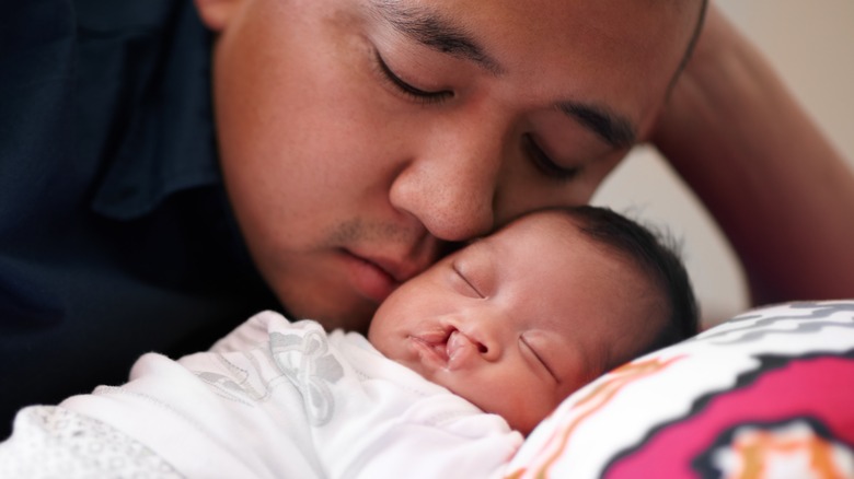 Baby with cleft lip or palate receiving love and support