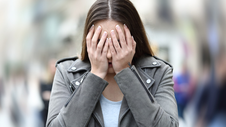 woman experiencing a panic attack on the street