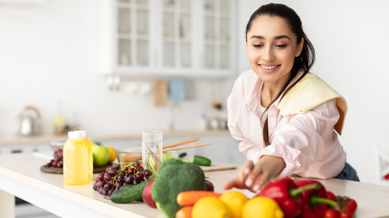 Woman reaching for fruits and vegetables