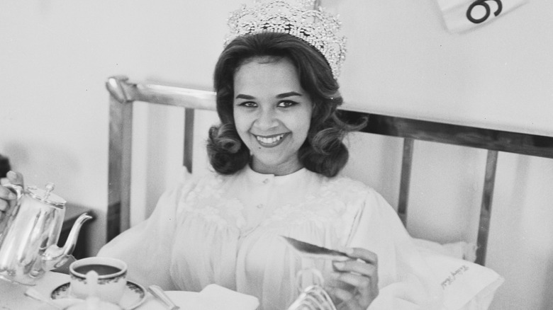 woman in 1960s eating breakfast in bed