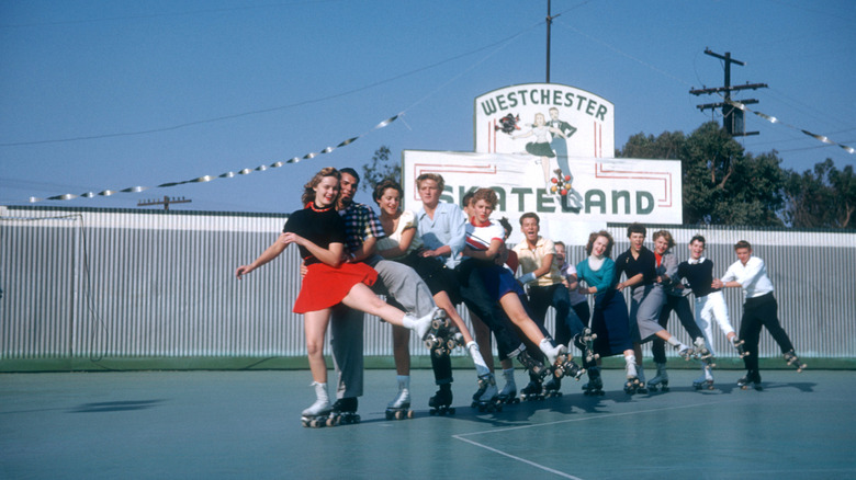 Friends roller skating in a conga line at the Westchester SkateLand
