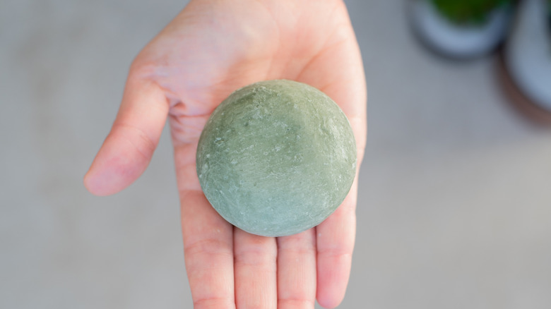 A hand holding a soap bar