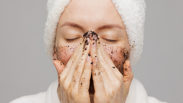 Woman scrubbing her face